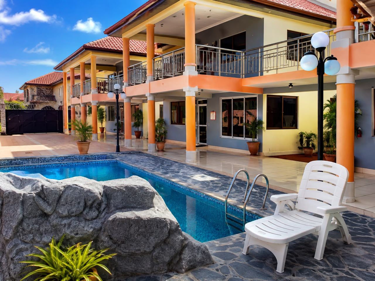 Exterior of Feeb Fiesta Hotel with marigold colonnade and pool
